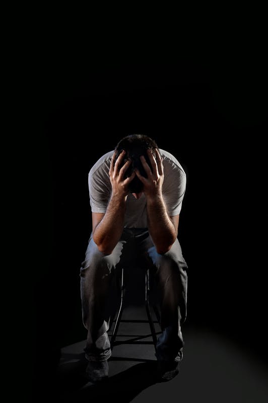 guy holding his head showing he is depressed