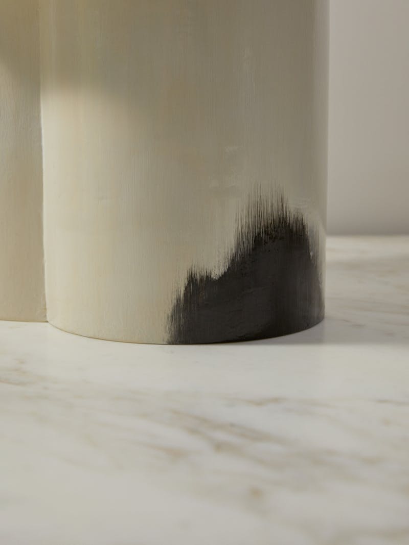detail image of a white and black lacquer side table designed to resemble horn material from makers destroyers/builders. 