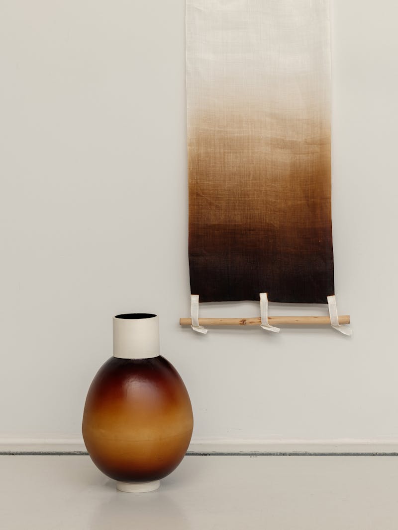 Colour image displaying Ott vase (left) and Mosi Wall Piece (right) by Korean designer Seok-Hyeon Yoon. The vase is made from Ott and the wall piece is made from traditional Korean Mosi fabric and coloured with Ott resin. The designs are part of the new 2024 spring collection 'Observations' by online gallery Metamorphoses Objects.