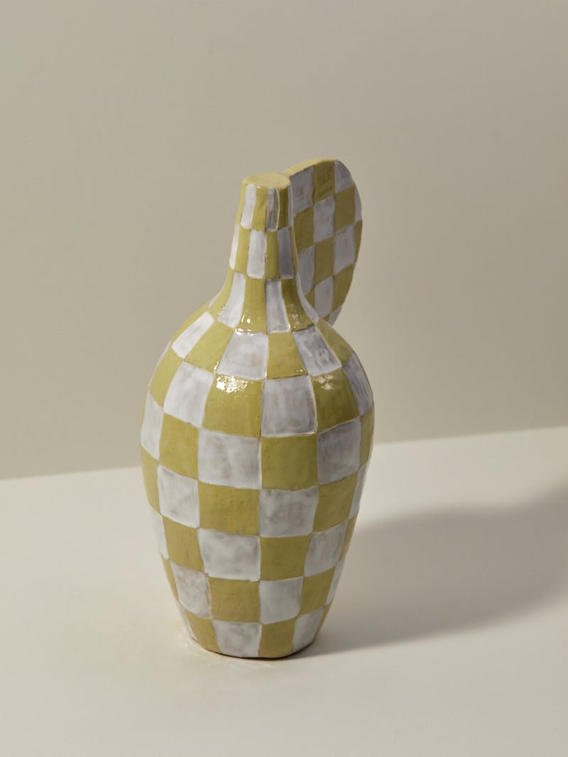 white and yellow checkered glazed ceramic vessel by Maria Lenskjold. 