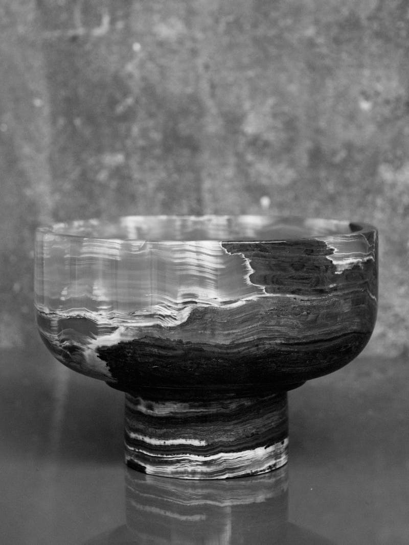 Black and white image displaying front view of Lotte Bowl in green onyx by Bloc Studios. This beautiful marble item is part of the new 2024 spring collection 'Observations' by online gallery Metamorphoses Objects.