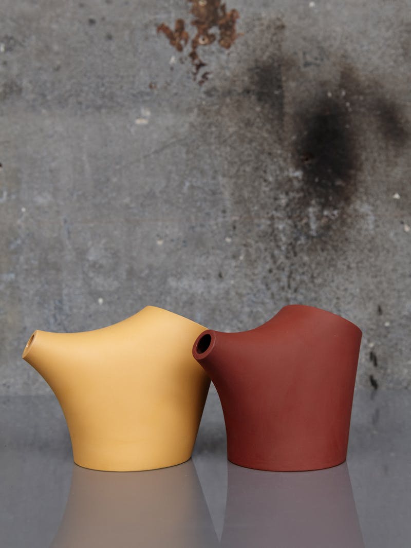 Colour image displaying Hop Step series in yellow (left) and red (right) by J. Hill's Standard. These objects belong to the new 2024 spring collection 'Observations' by online gallery Metamorphoses Objects.