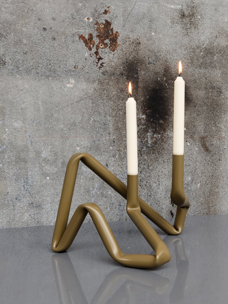 Colour image of the handmade Bucatini aluminium candle holder in green matte by Danish design studio A.O.T. The object is part of the new 2024 spring collection 'Observations' by online gallery Metamorphoses Objects.