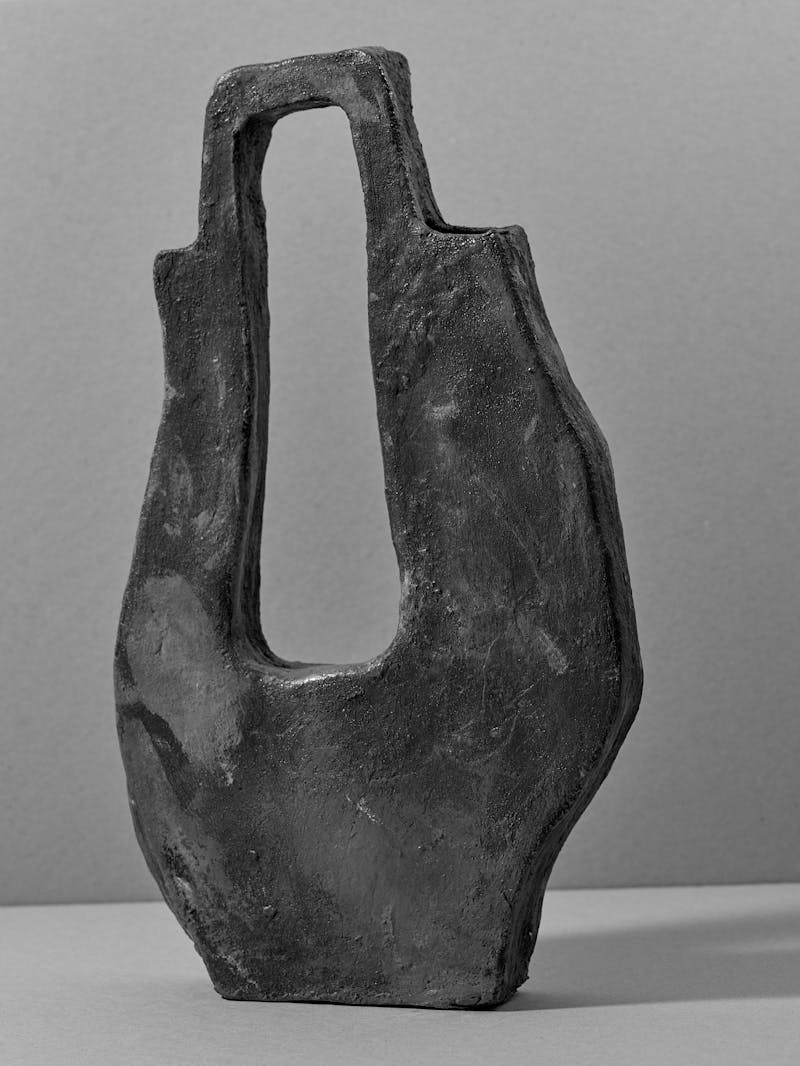 black and white image of a handmade sculptural ceramic vessel with a hollowed centre handle by Willem van Hooff a designer and craftsman from Eindhoven.