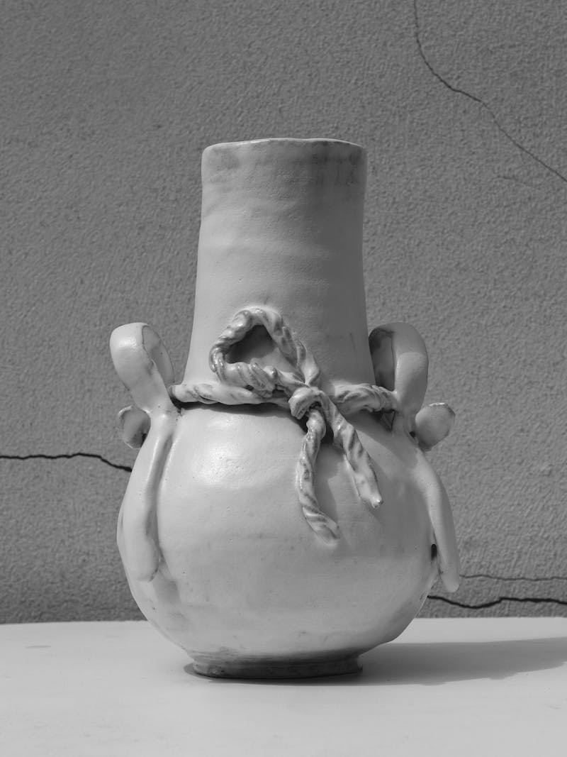 Black and white image displaying frontal view of "Never Been to Japan" Vase I by Juliette Teste in 2024. The beige-coloured ceramic vase is handmade from glazed stoneware clay. This object is part of the new 2024 spring collection 'Observations' by online gallery Metamorphoses Objects. 