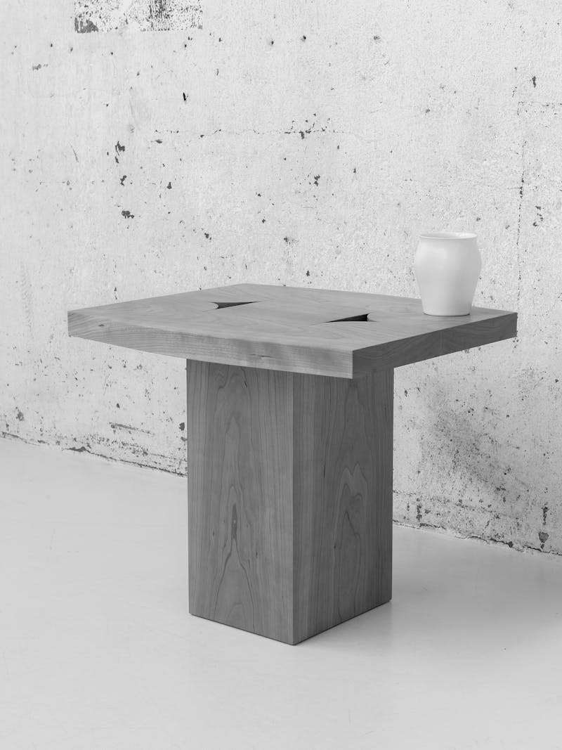 Black and white  image displaying overhead view of 'Locking Table' by Maria Tyakina, 2024. The material is made from European cherry wood. This furniture piece is exclusively made for the new 2024 spring collection 'Observations' by online gallery Metamorphoses Objects.