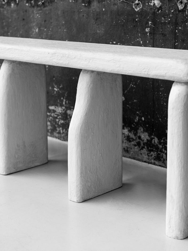 Black and white image displaying details of the Bo Bardi Bench by Linde Freya Tangelder from design studio Destroyers/Builders. This design piece is made from Ayous wood and wood composite, and belongs to the new 2024 spring collection 'Observations' by online gallery Metamorphoses Objects.