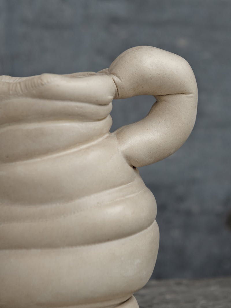 Colour image displaying close-up detail of handle of Chub Vase I by Tessa Silva. The material is made from the 'Chalk & Cheese' technique developed by manipulating proteins from fermented skimmed milk. This vase is exclusively made for the new 2024 spring collection 'Observations' by online gallery Metamorphoses Objects. 