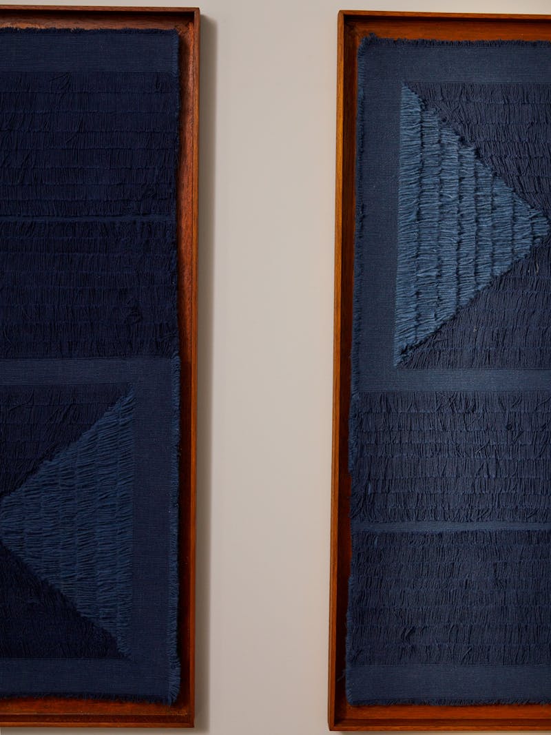 detail image of dark blue frayed textile diptych in a wooden frame by New Zealand born and Berlin based fibre artist and designer Sophie Rowley.  The wall works are geometric in a pattern and hand made unique pieces. 