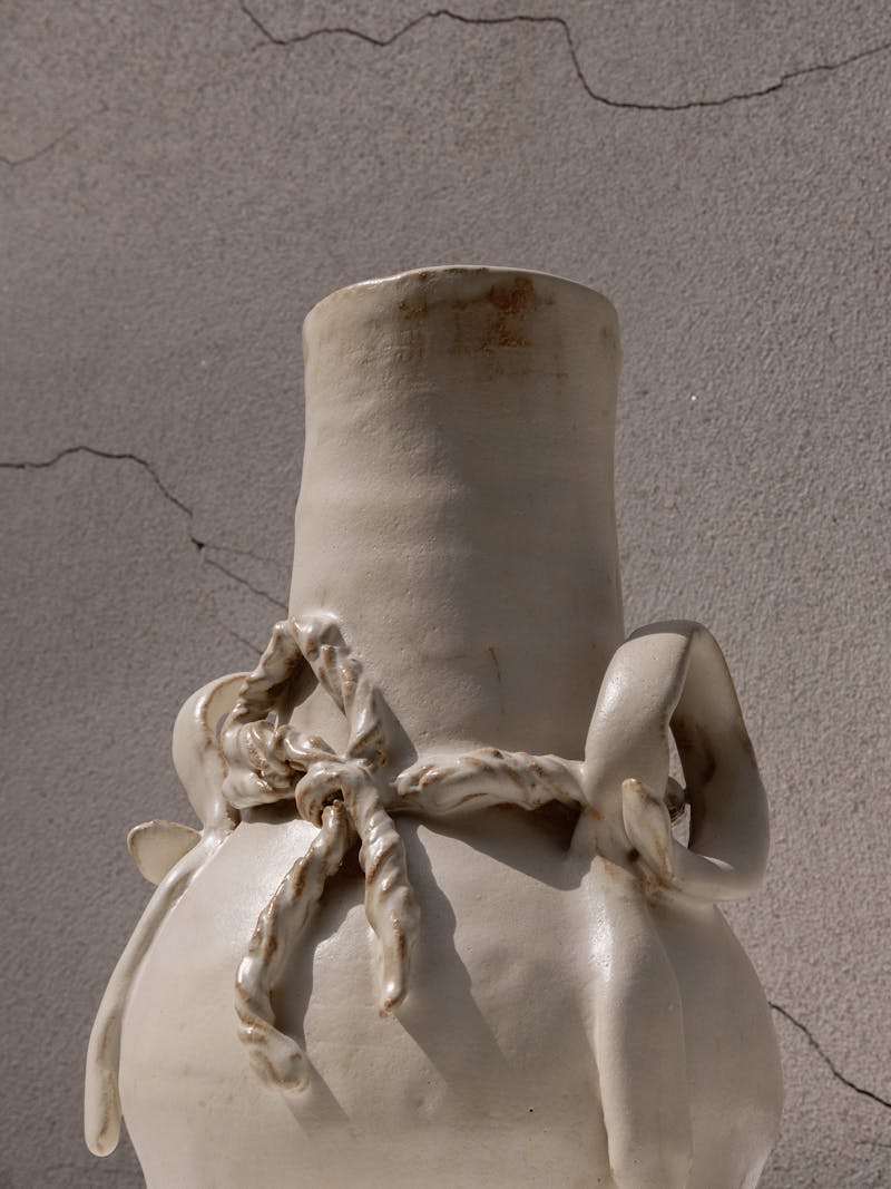 Colour image displaying frontal detail of "Never Been to Japan" Vase I by Juliette Teste in 2024. The beige-coloured ceramic vase is handmade from glazed stoneware clay. This object is part of the new 2024 spring collection 'Observations' by online gallery Metamorphoses Objects. 
