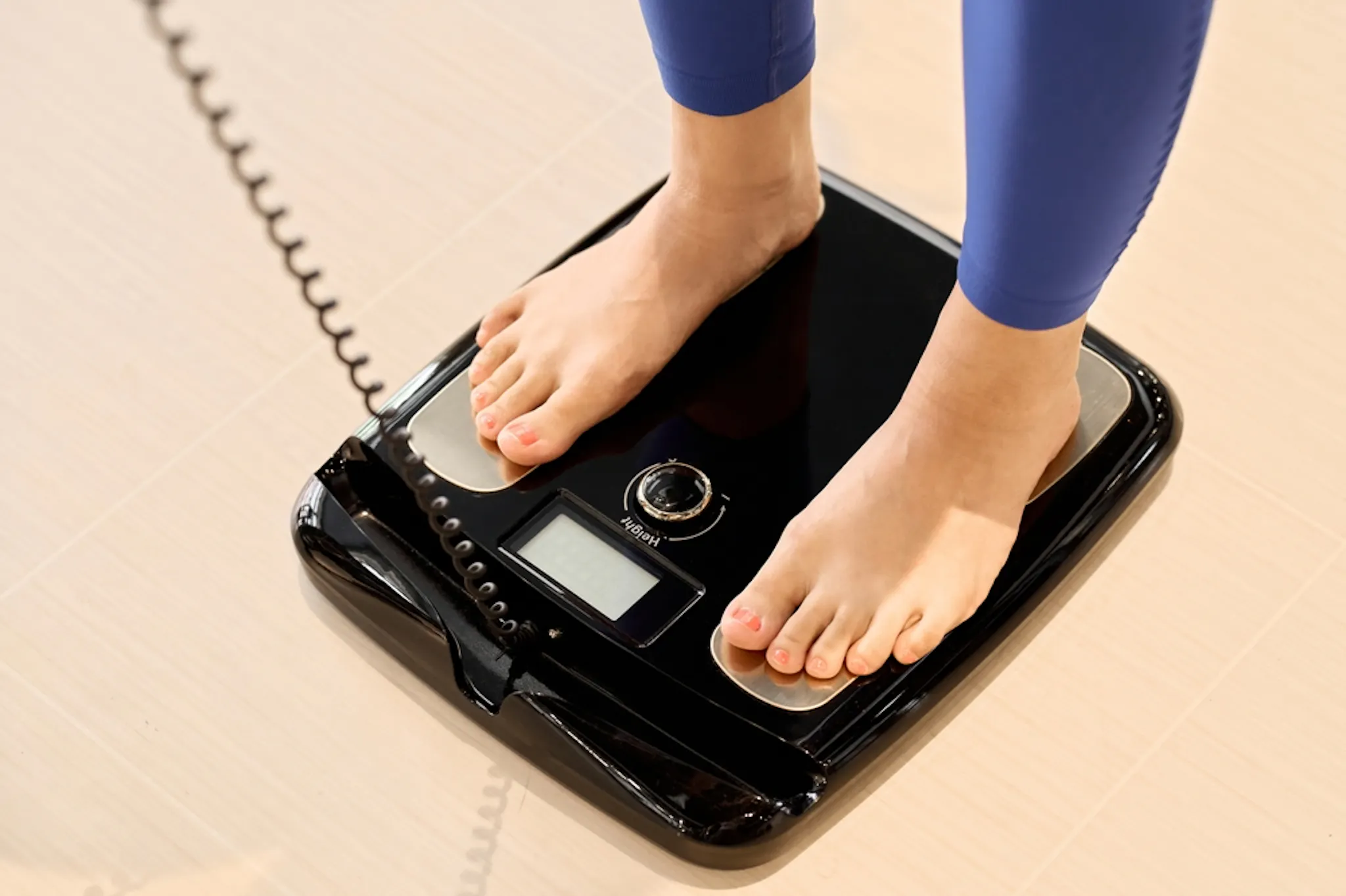 Woman measuring for visceral fat check