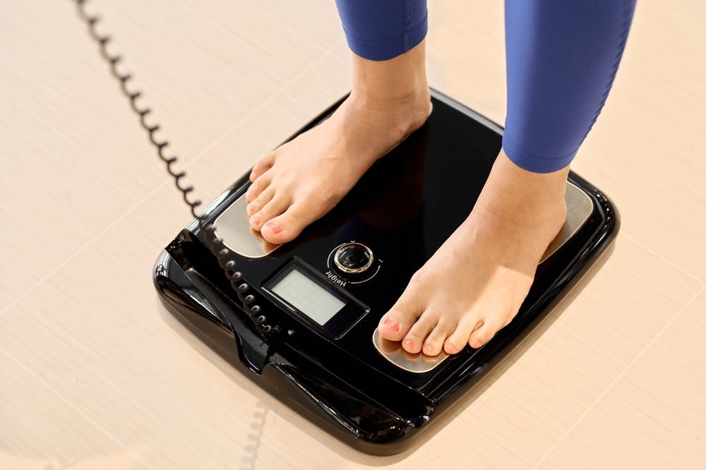 Woman measuring for visceral fat check
