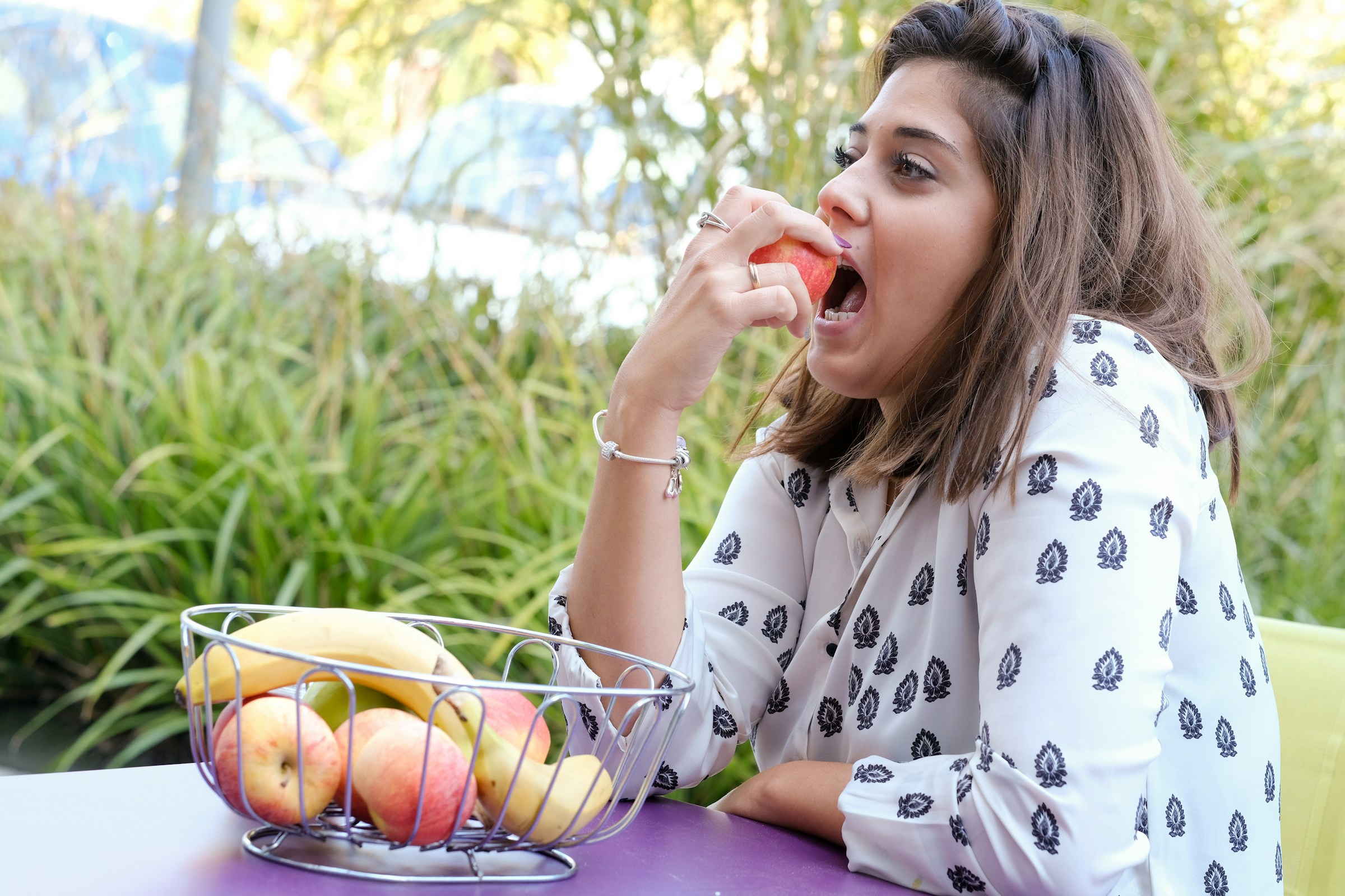 A lady enjoying a fruit