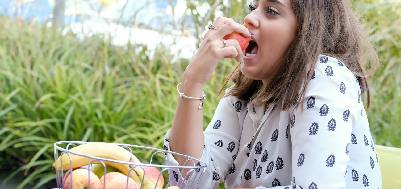 A lady enjoying a fruit