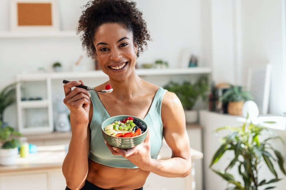 A lady eating healthy high-protein foods for fat loss