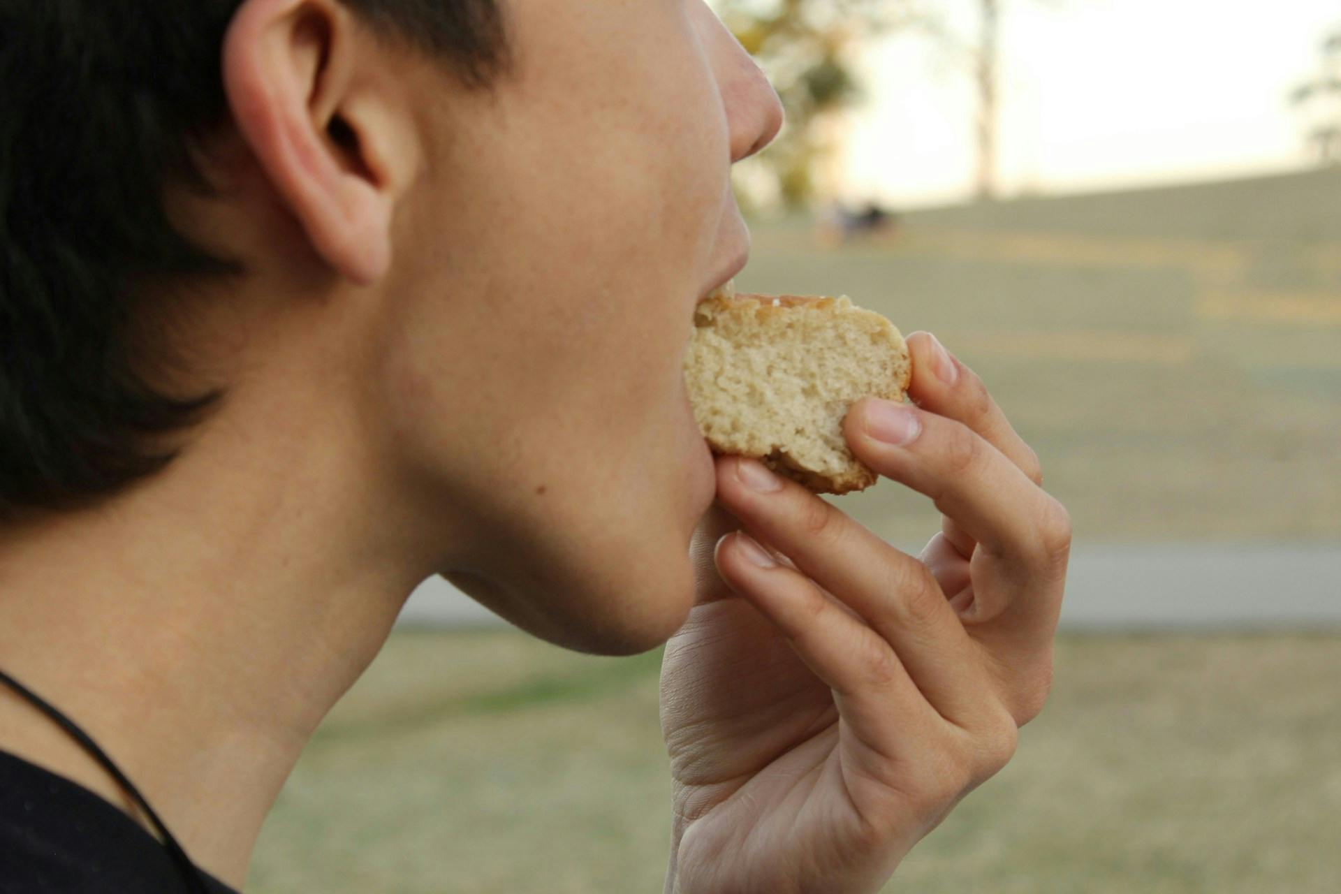 A person eating white bread
