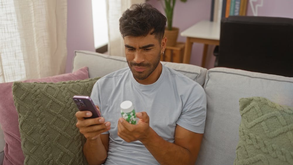 A young man checking metformin dosage