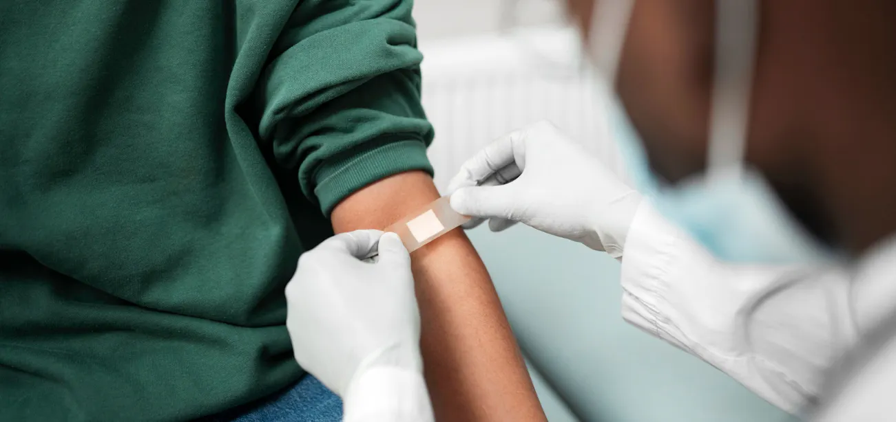 Person with diabetes donating blood safely