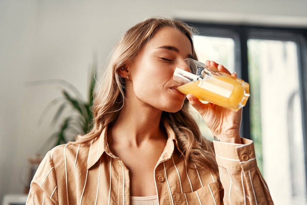 A lady taking a high fructose drink