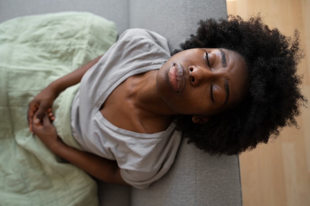 Lady feeling bloated due to fructose malabsorption
