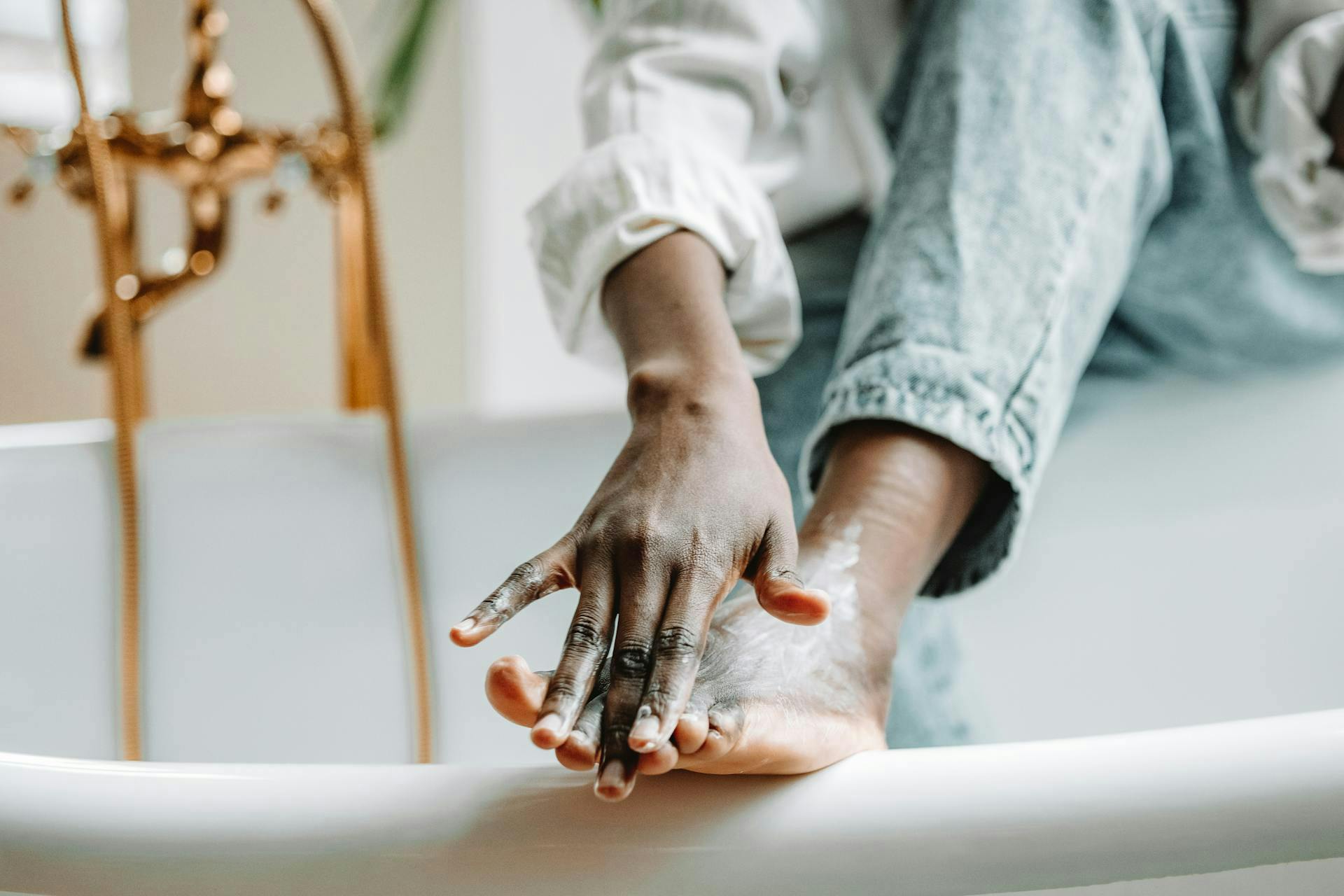 woman applying moisturizer to feet to reduce wrinkles