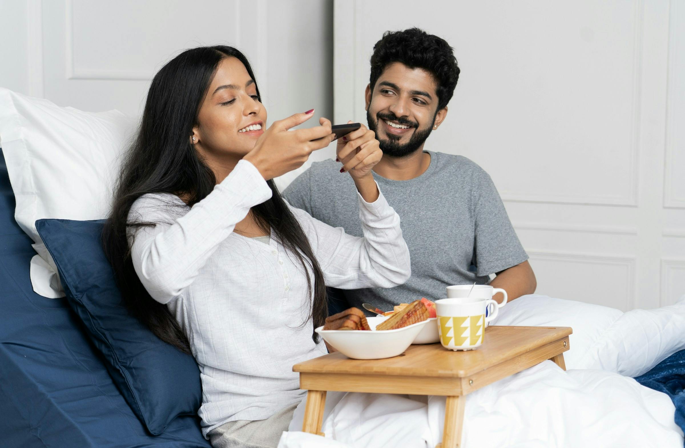 Couple sharing a healthy meal in bed