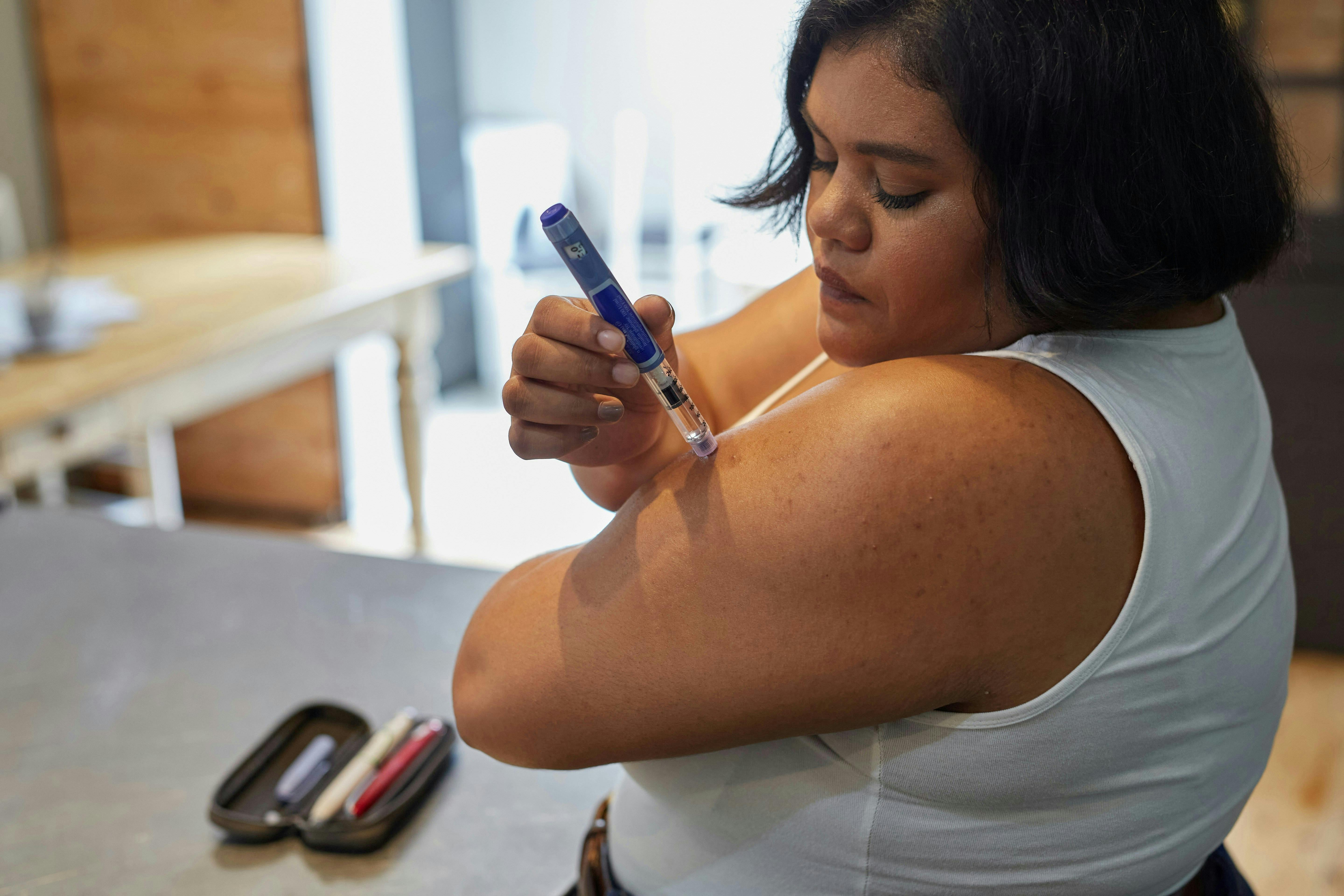 A lady taking a weight loss injection