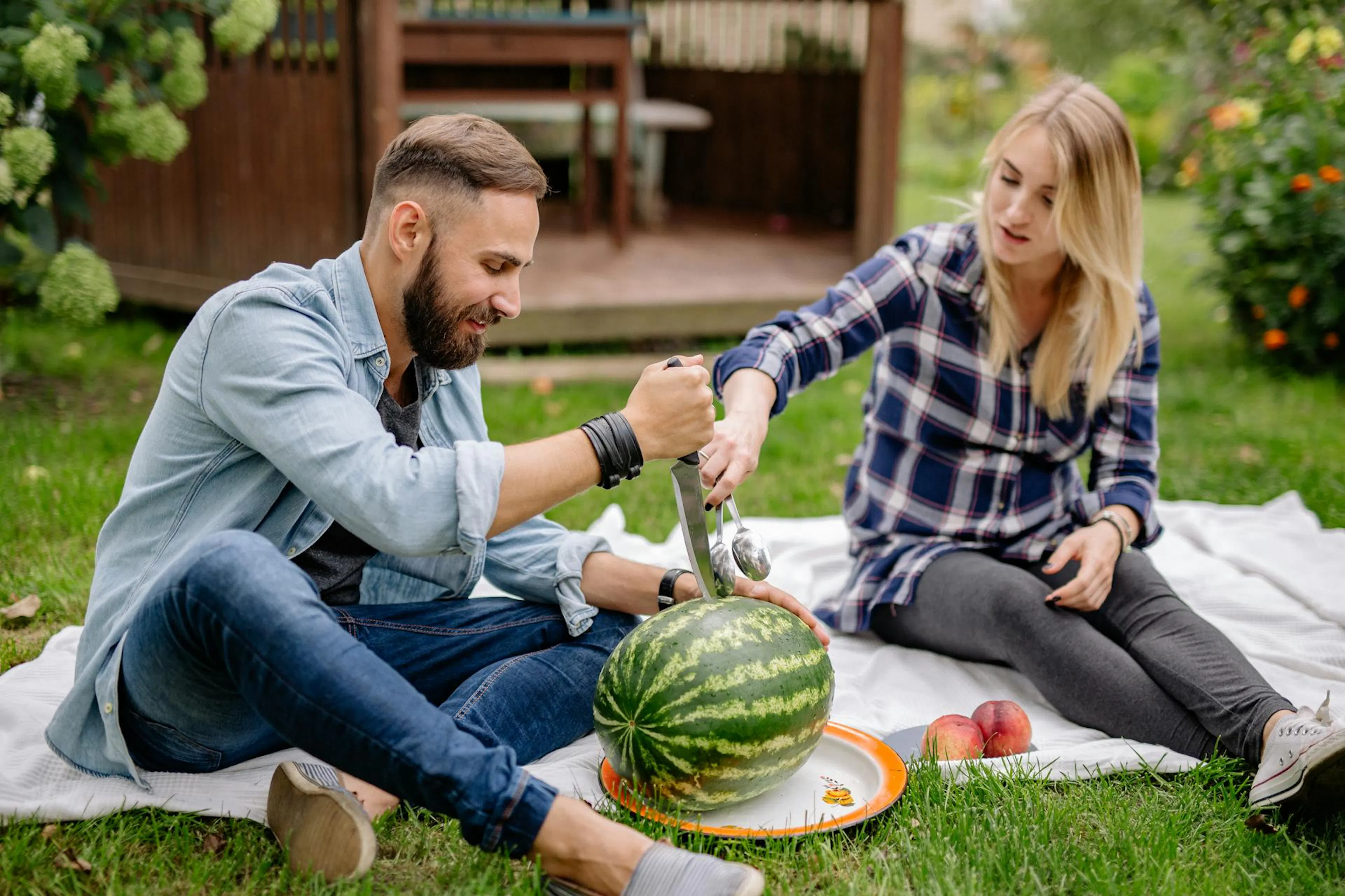 A couple cutting a watermelon fruit rich in libido boosting components
