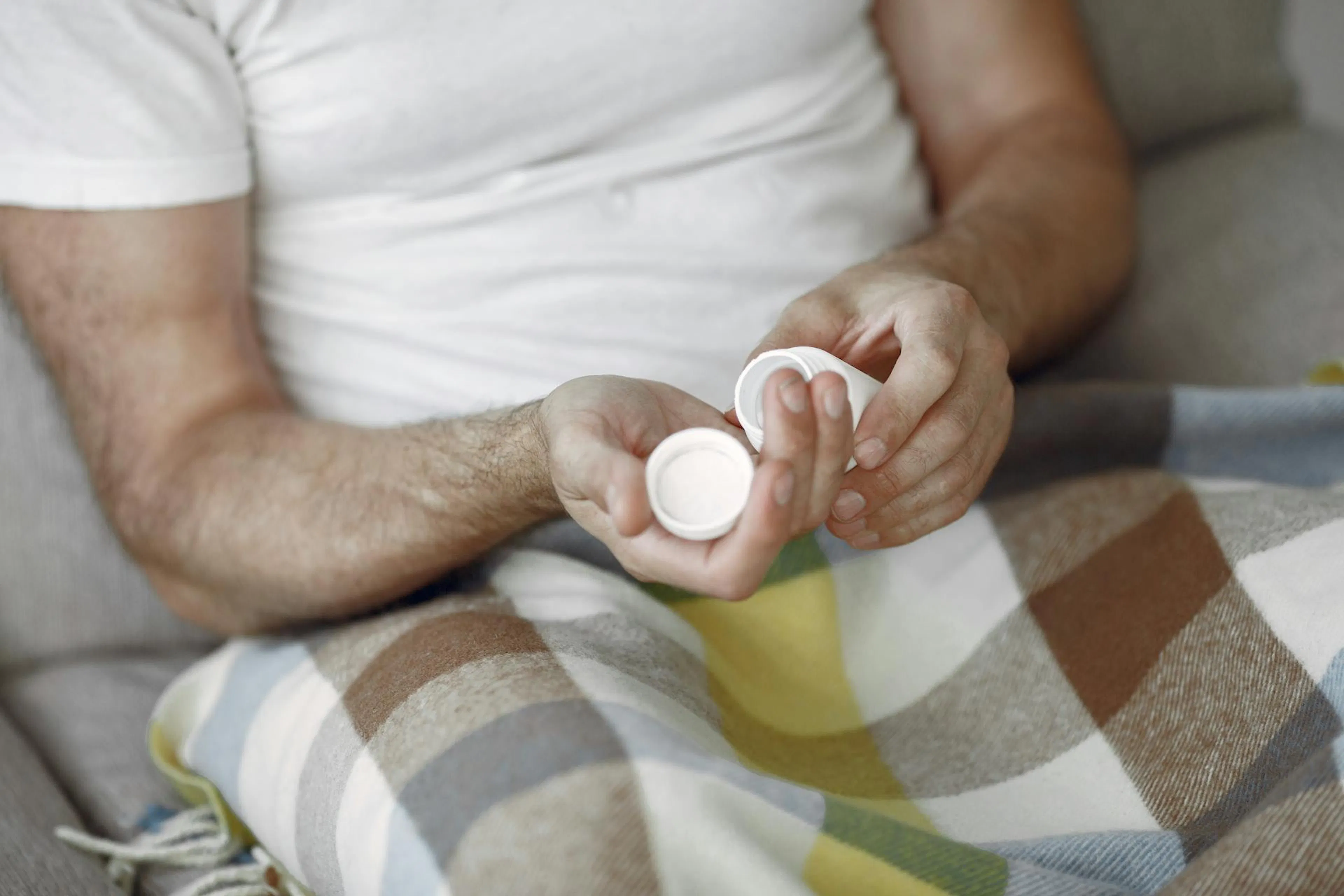Man holding supplement bottle for testosterone booster