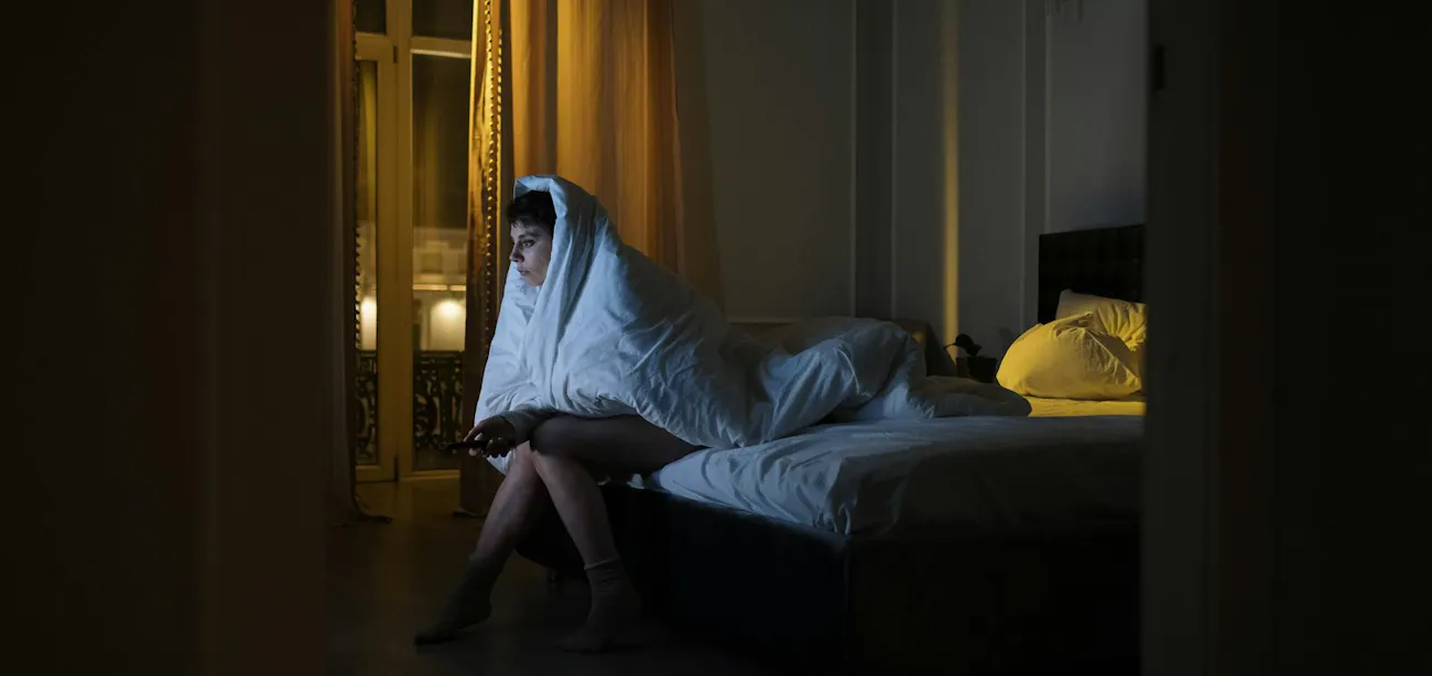 Person choosing TV over sleep