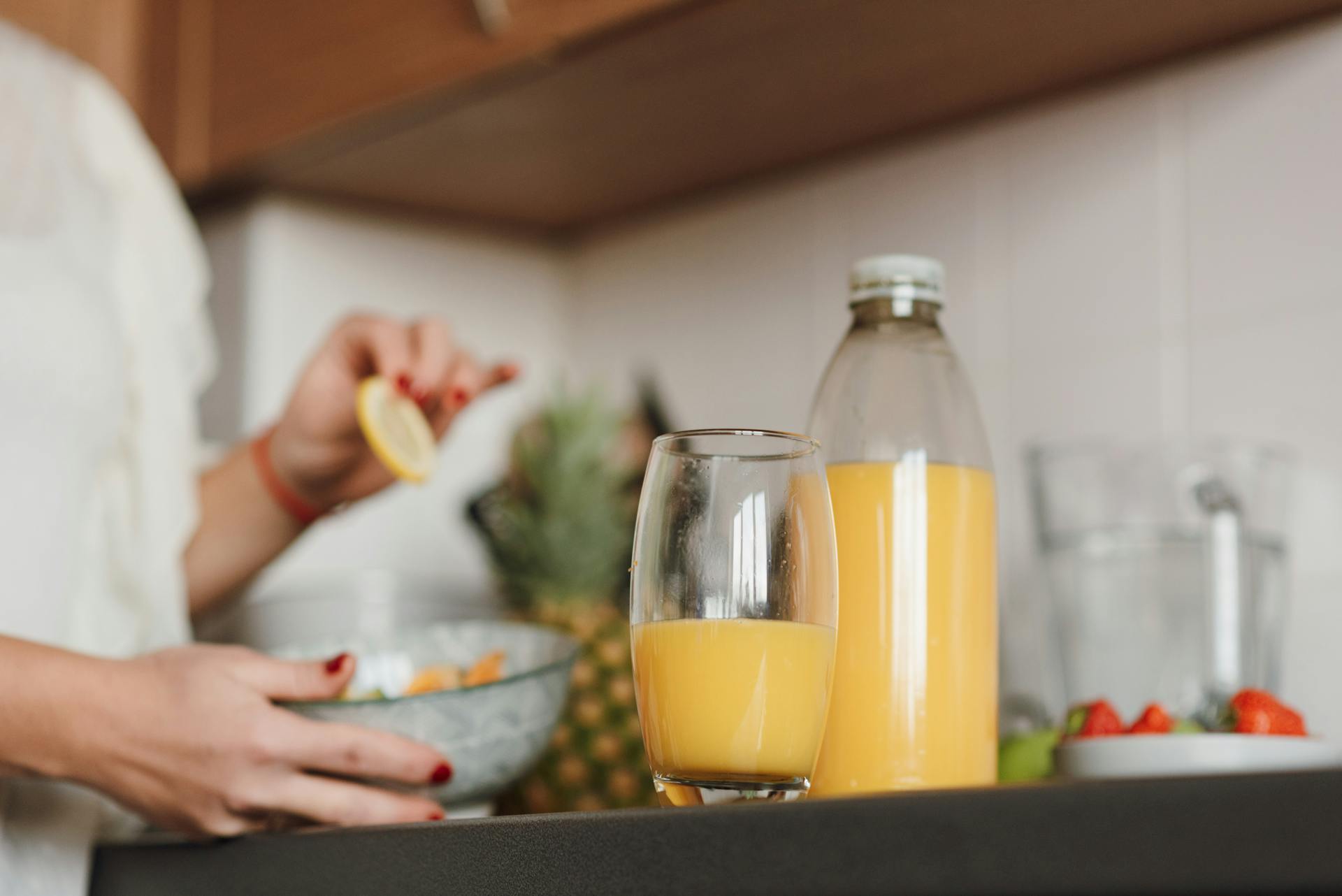 Glass of fresh pineapple juice on a kitchen counter