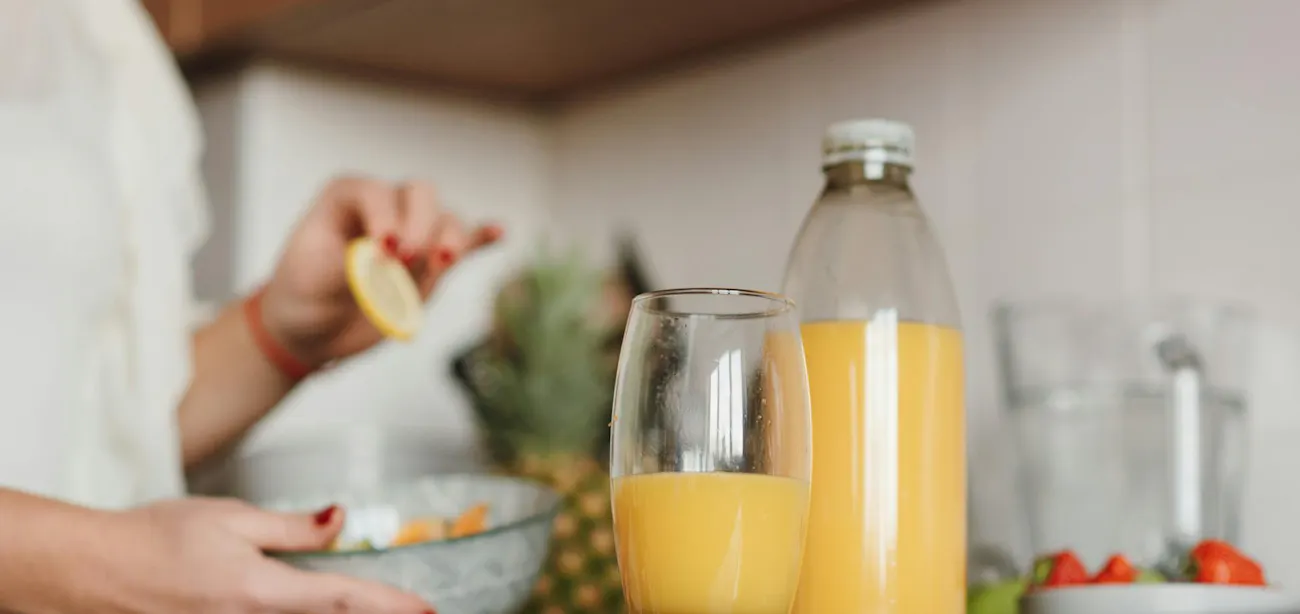 Glass of fresh pineapple juice on a kitchen counter