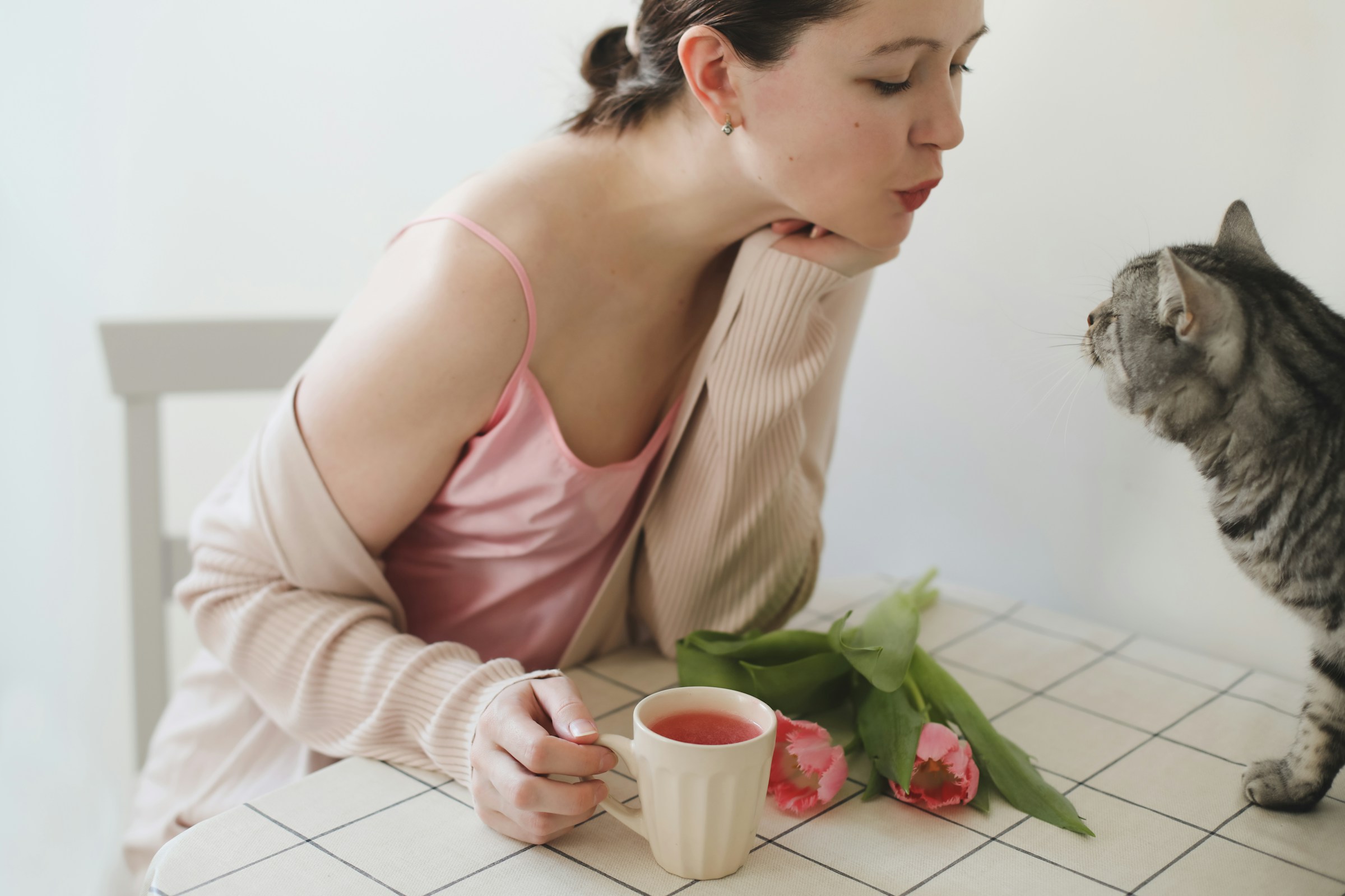 Woman with Glass of cranberry juice with fresh cranberries on a wooden table