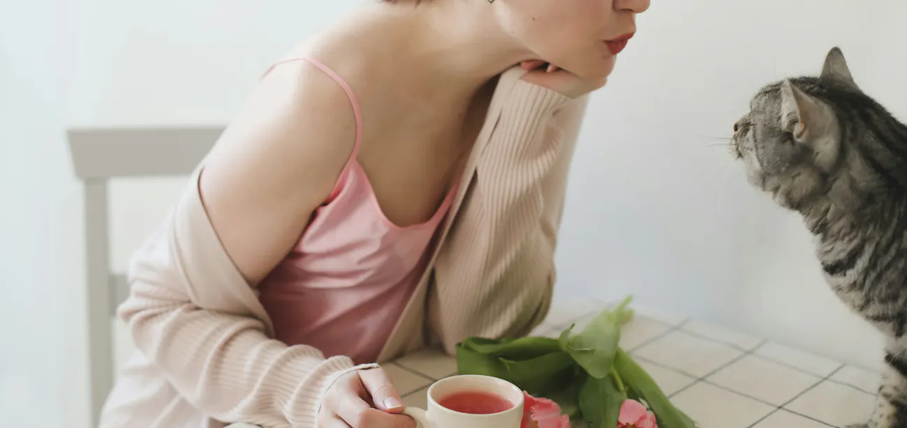 Woman with Glass of cranberry juice with fresh cranberries on a wooden table
