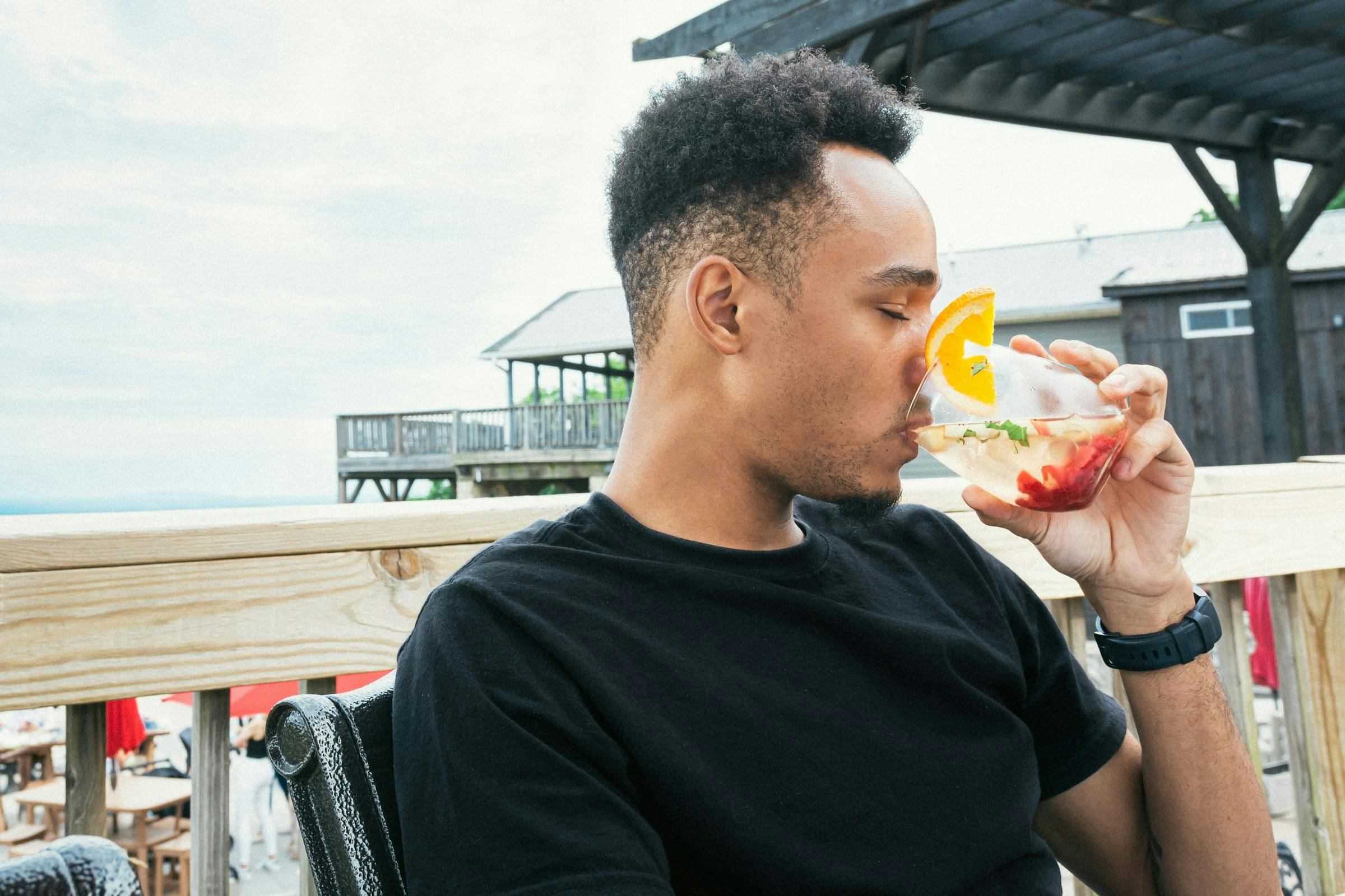 Guy taking cranberry juice to help lower blood pressure and support heart health.