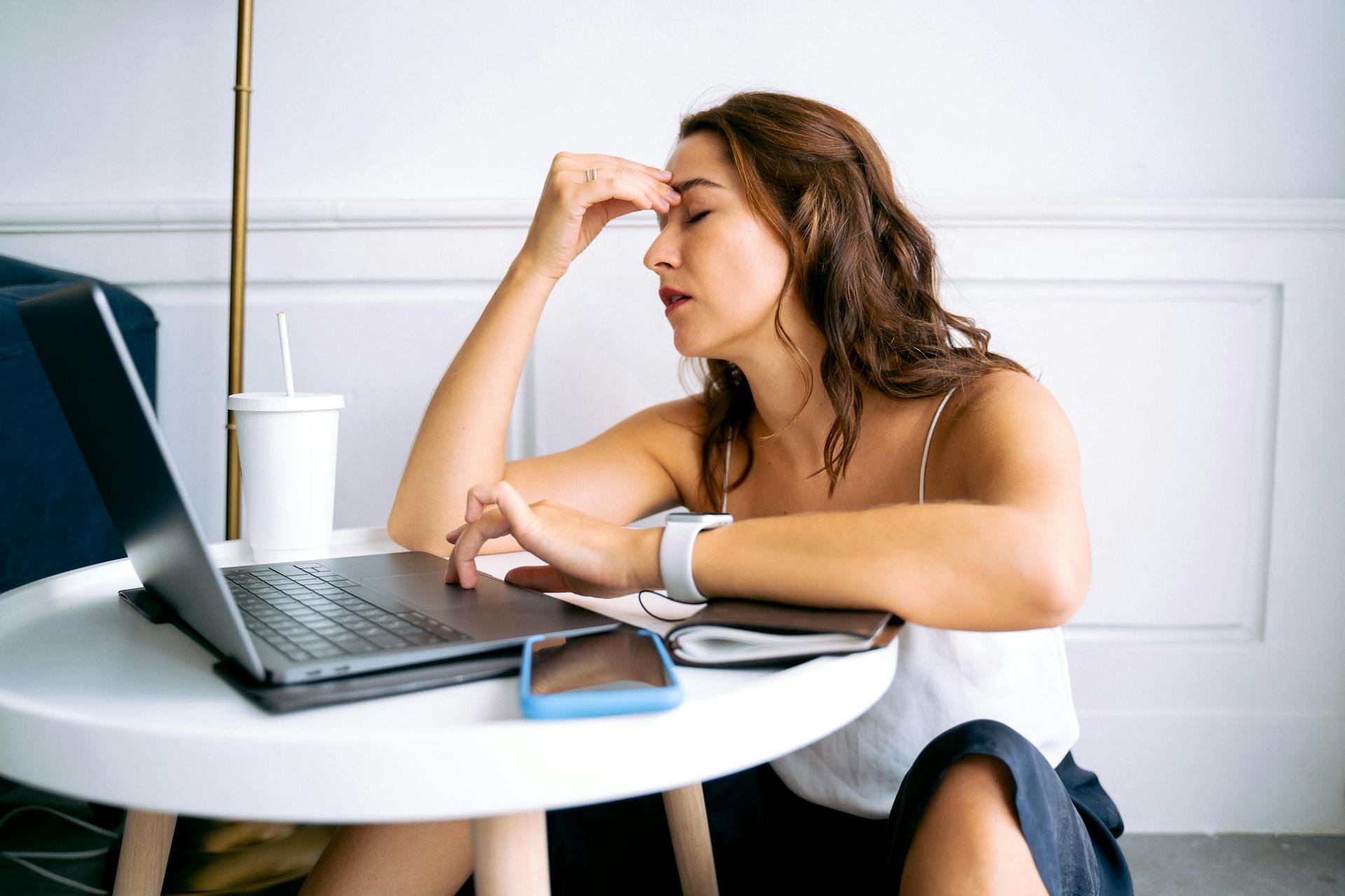 Person holding head with discomfort during keto diet