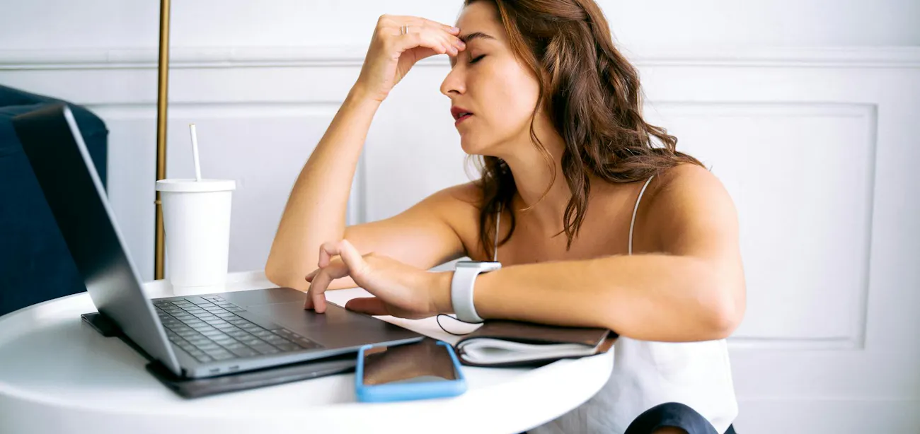 Person holding head with discomfort during keto diet