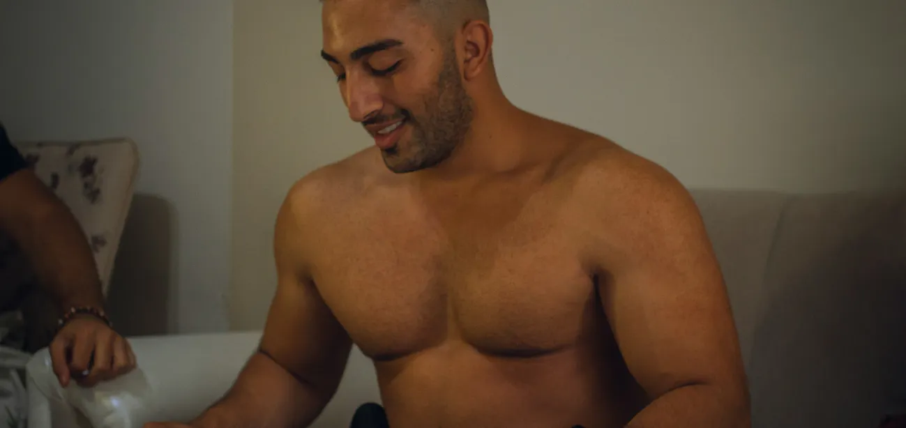 Man checking weight scale after starting testosterone therapy