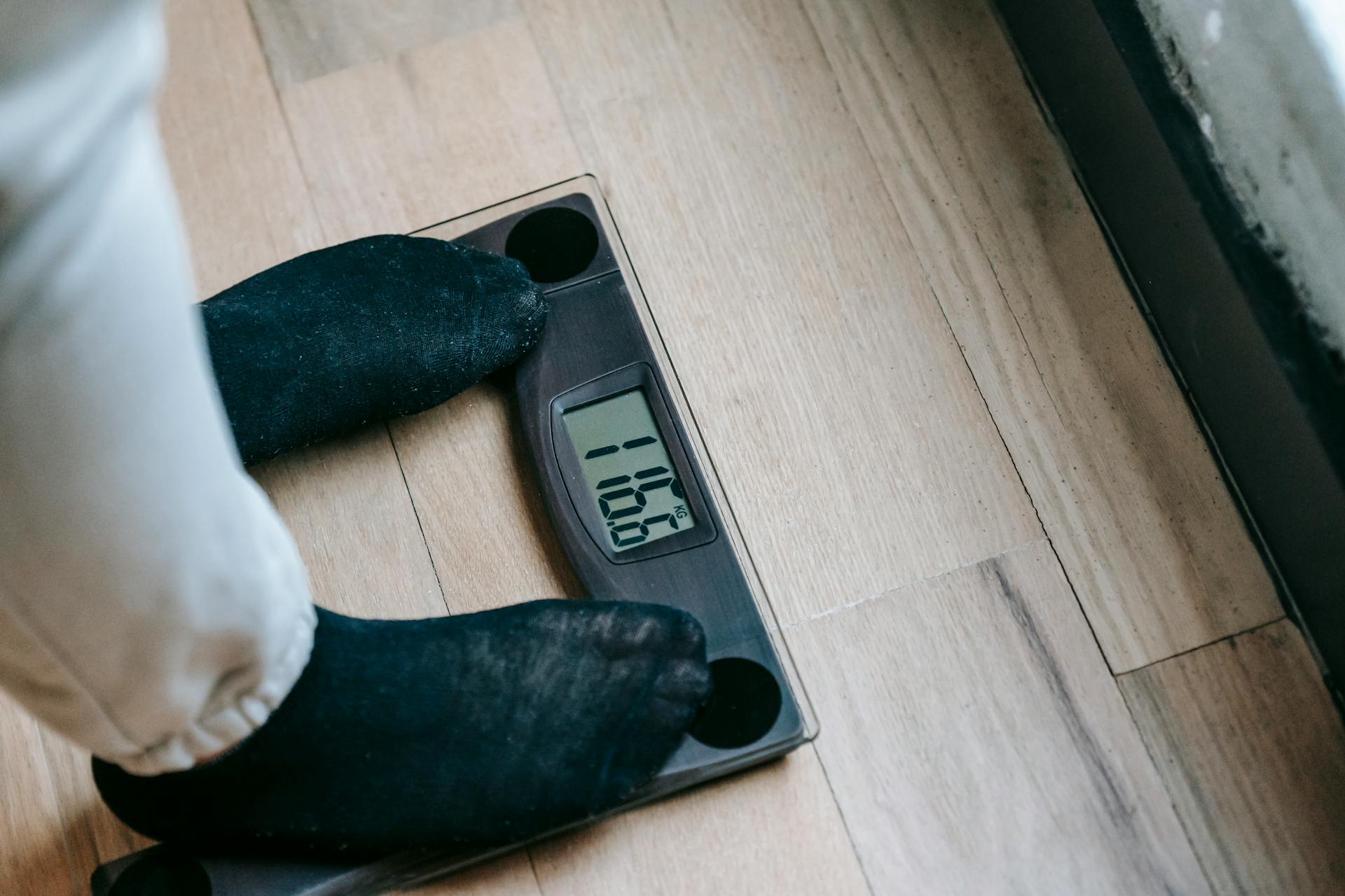 A person checking their weight