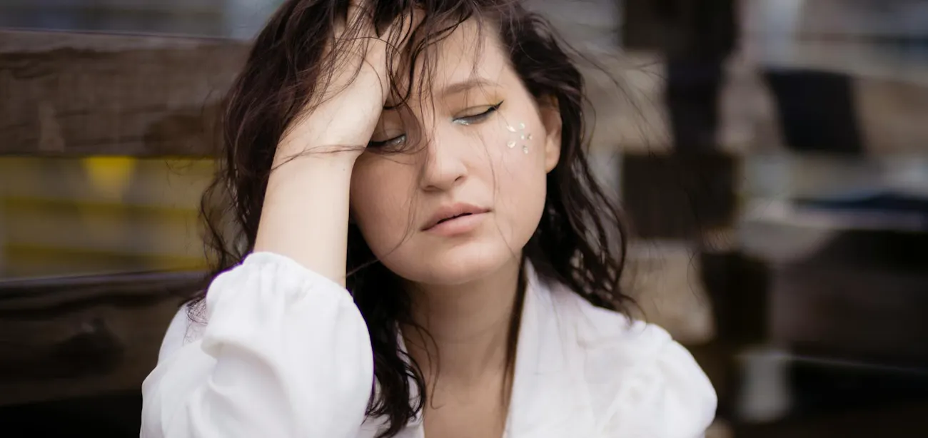 A lady feeling stressed and releasing cortisol hormone