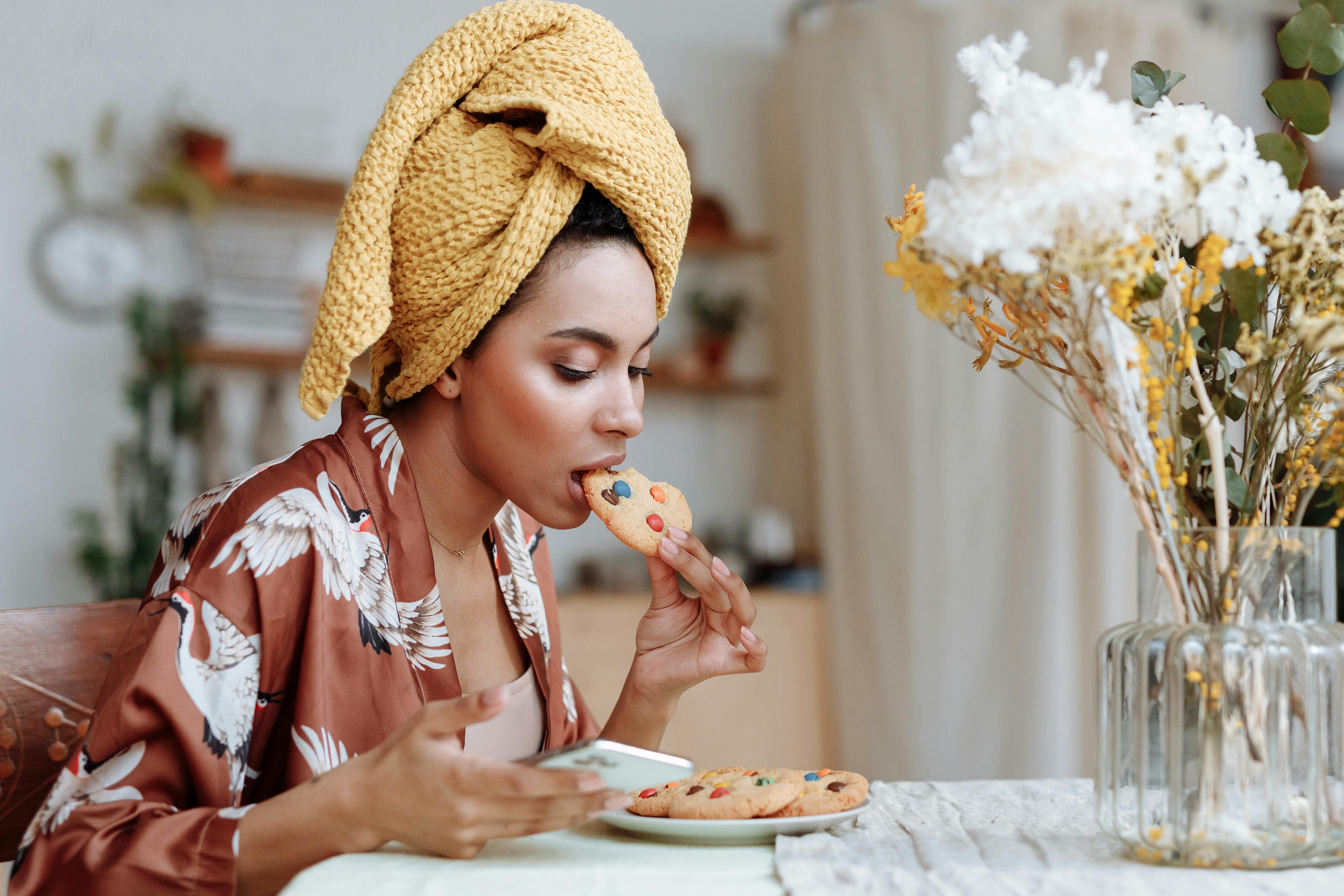 A lady eating a cooking high in sucrose
