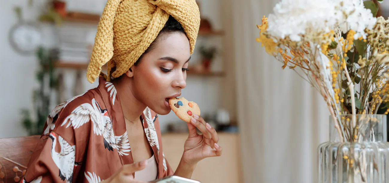A lady eating a cooking high in sucrose