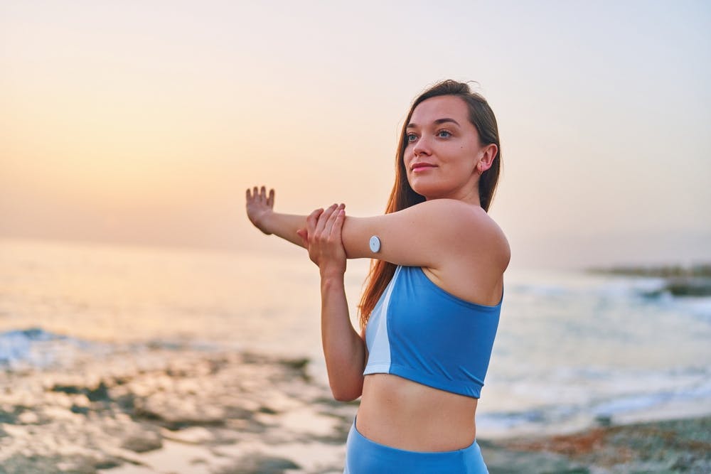 A lady with a Continuous Glucose Monitoring (CGM) patch