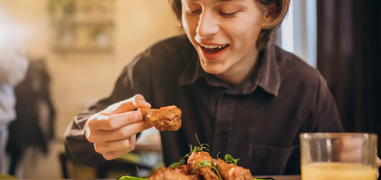 A person eating chicken instead of beef