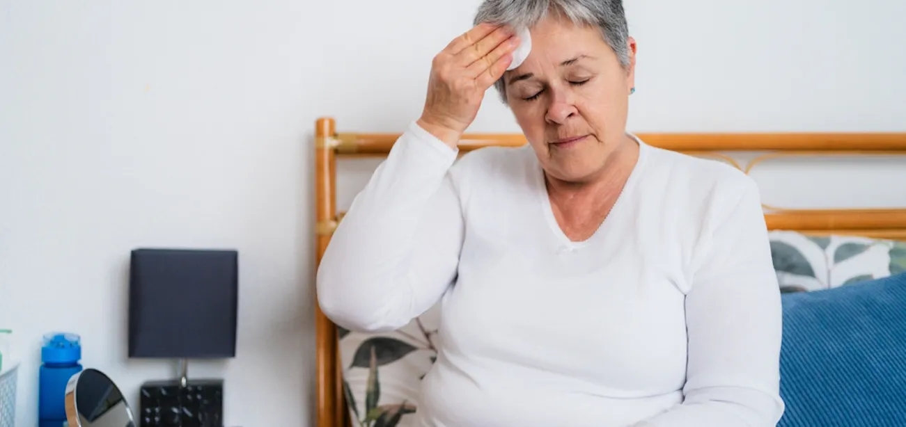 Woman experiencing hot flash and headache during menopause
