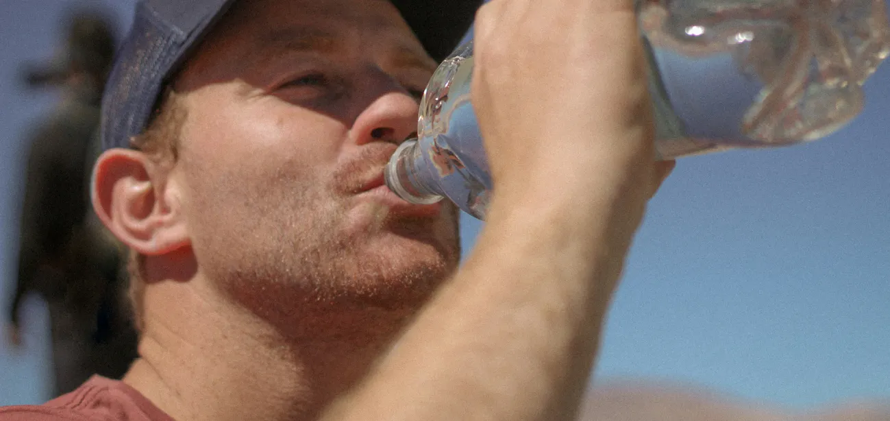 A person drinking propel water for electrolyte