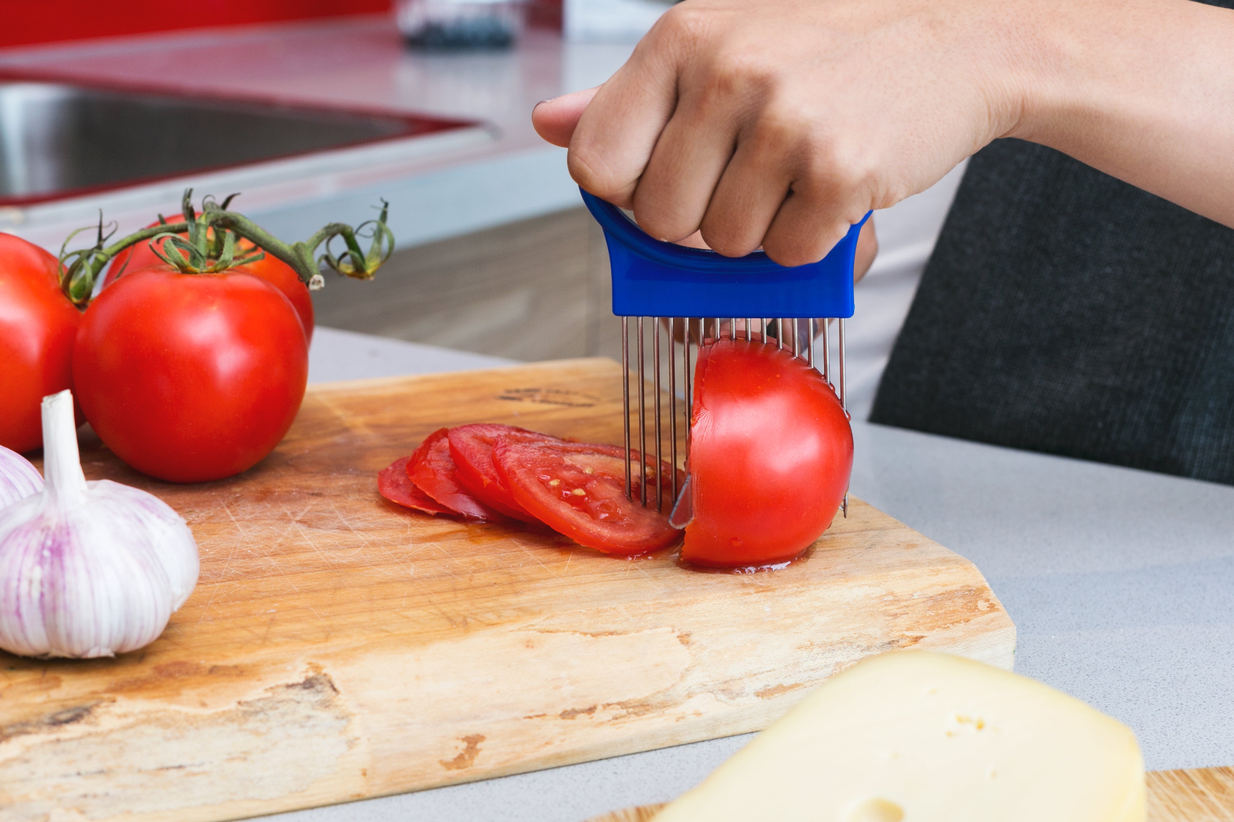 Person slicing tomatoes