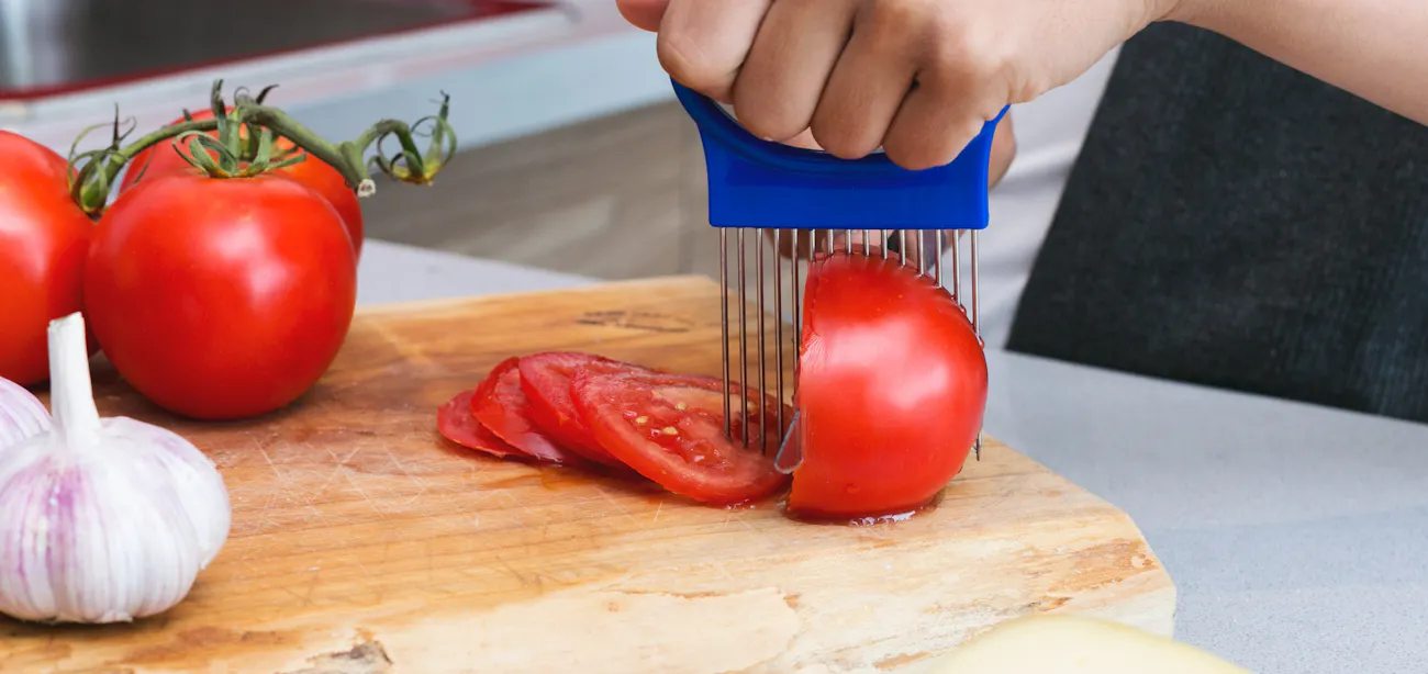 Person slicing tomatoes