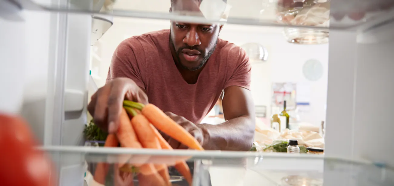 Person with diabetes preparing carrots with a balanced meal