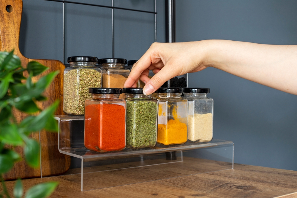Person selecting different spices that replaces coriander in a meal